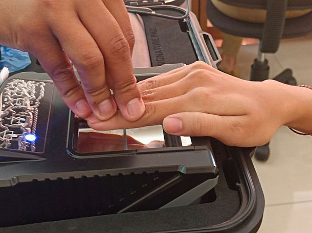 A person 's hand is being scanned by a device that says biometrics