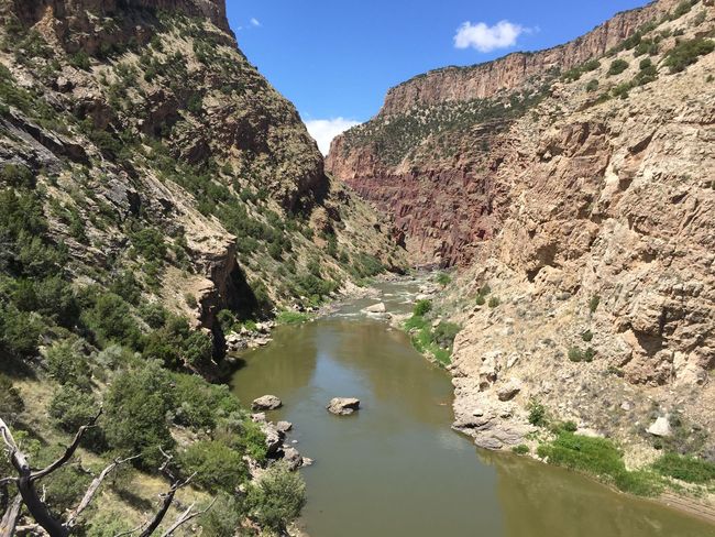 A river runs through a canyon between two mountains.