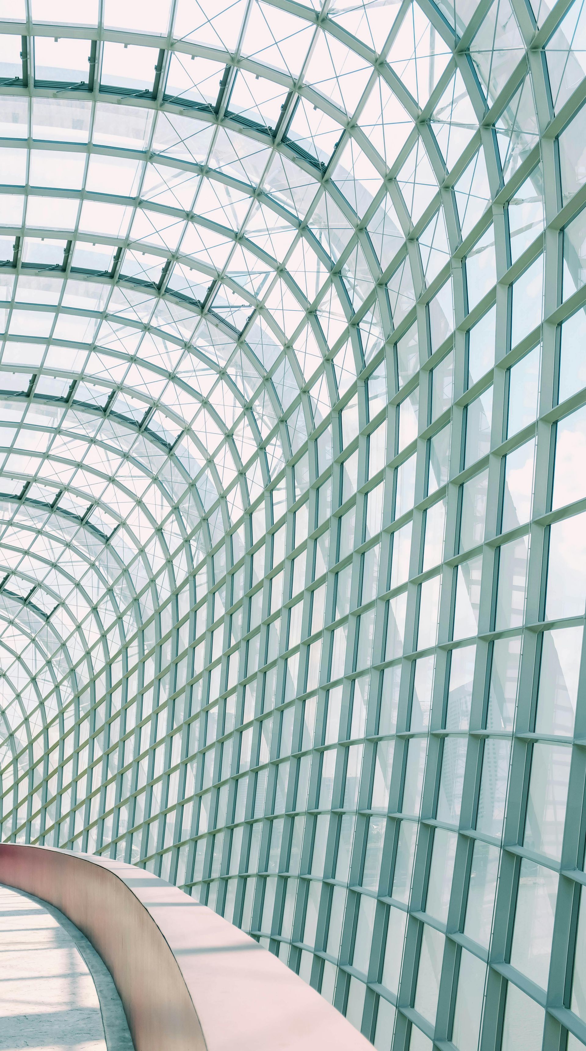 A tunnel with a lot of windows and a curved ceiling.