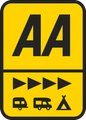A yellow road sign with the letters 