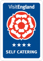 VisitEngland logo featuring a red Tudor rose above four stars and the text 