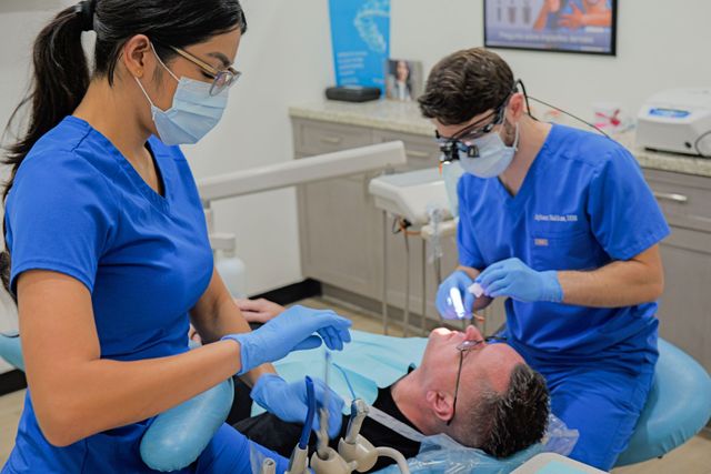 Top Dentist in Houston TX 77042 Working on Male Dental Patient | Best Root Canals, Dentures, Invisalign Treatment