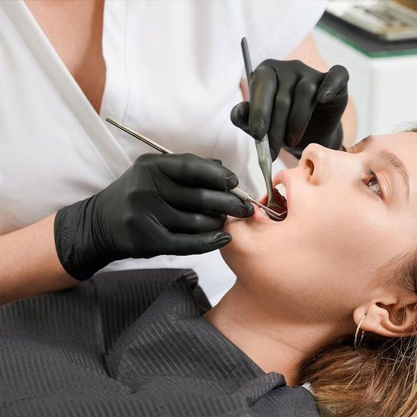 female patient getting teeth inspection | Bite Adjustments | Occlusal Adjustment Houston TX 77042
