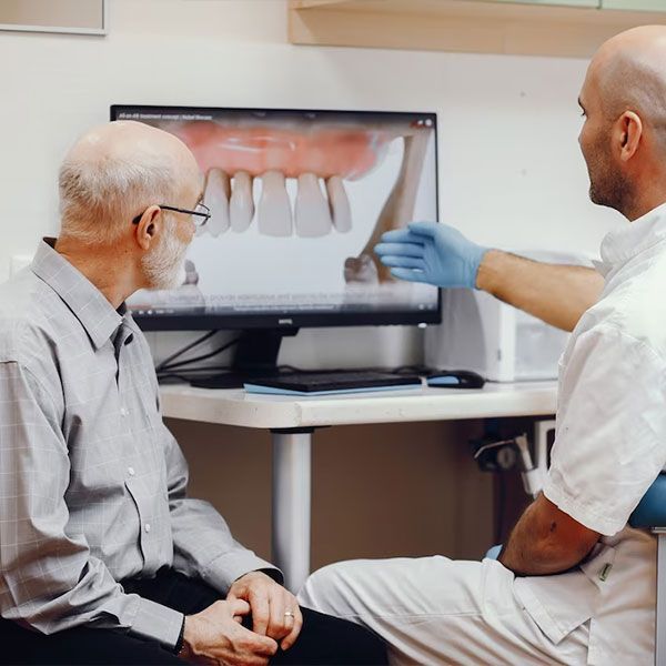 dentist showing teeth scan | Dental Implants | Best Houston TX 77042 Dentist