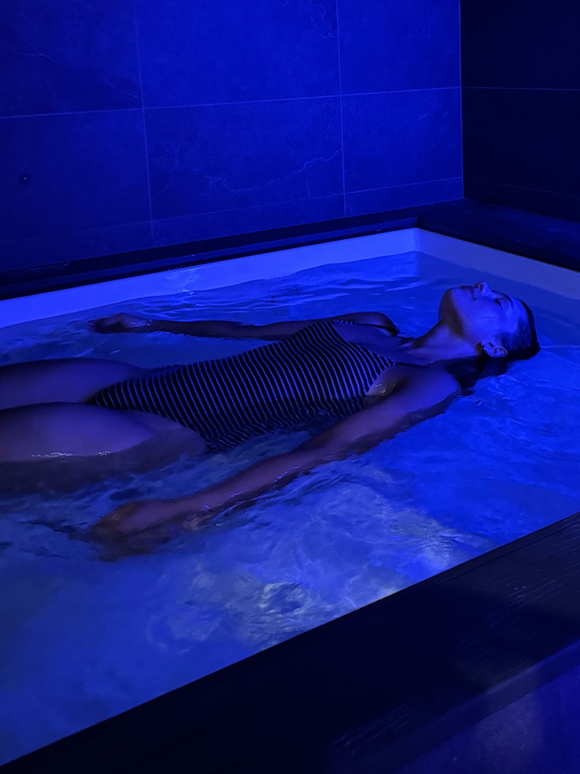 Woman floating in a tank