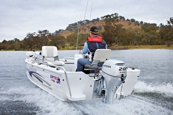Man Driving a Boat — Marine Products & Repairs in Mackay, QLD