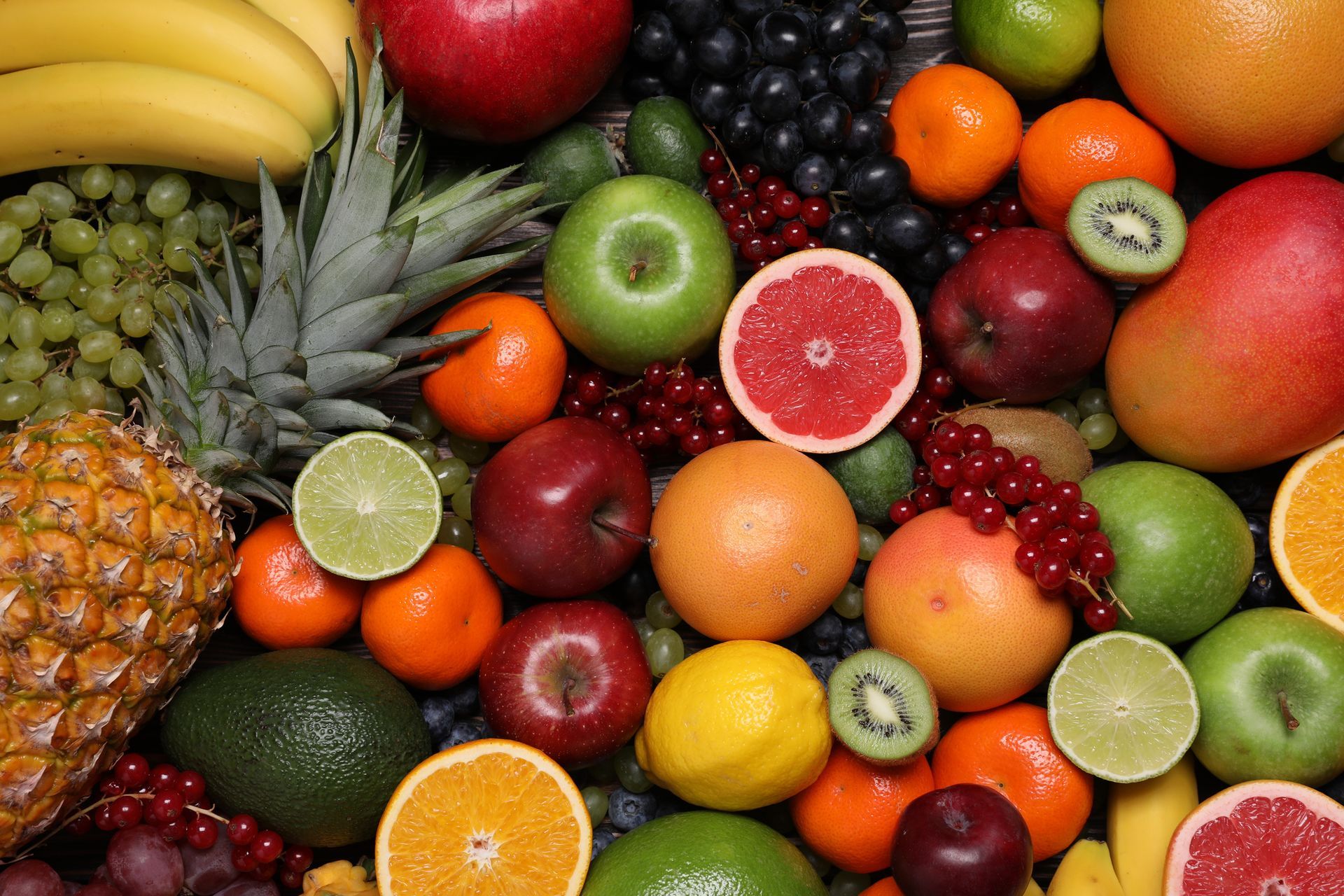 A variety of fruits and vegetables are displayed on a table