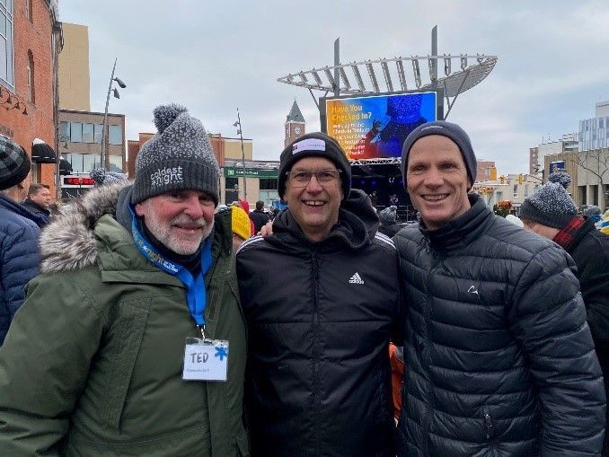 A man and a clown pose for a picture together