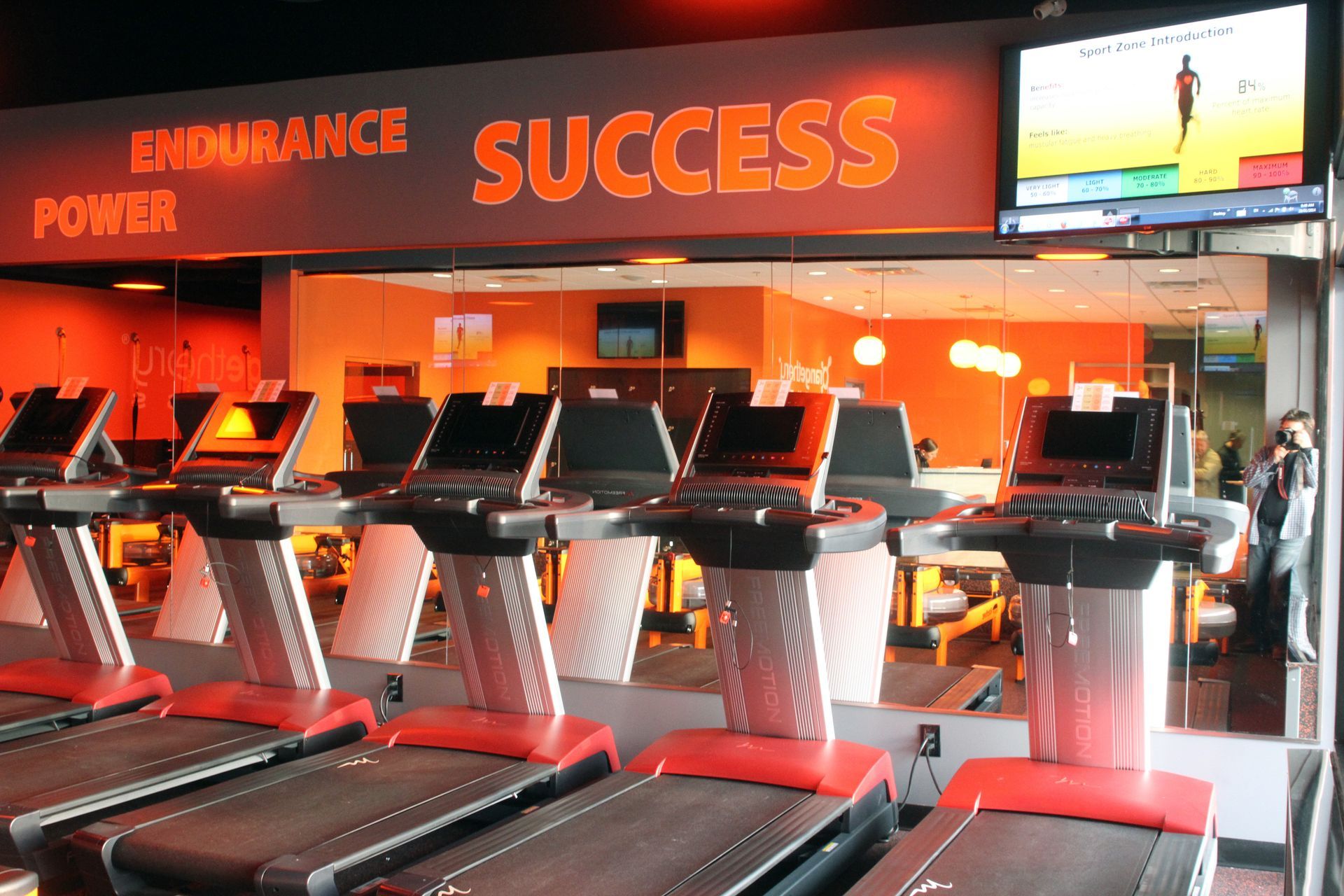 A gym with treadmills and a sign that says success