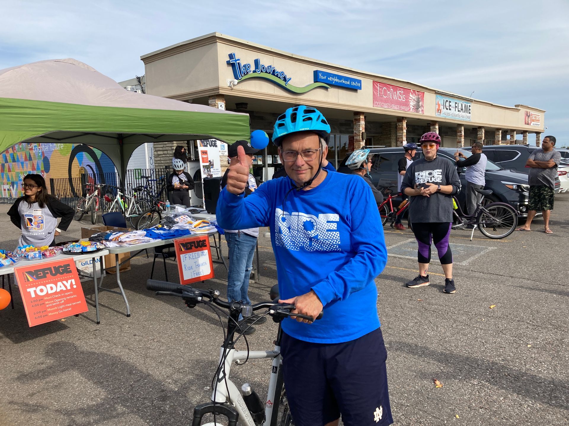 A group of people posing in front of a wall that says attrell