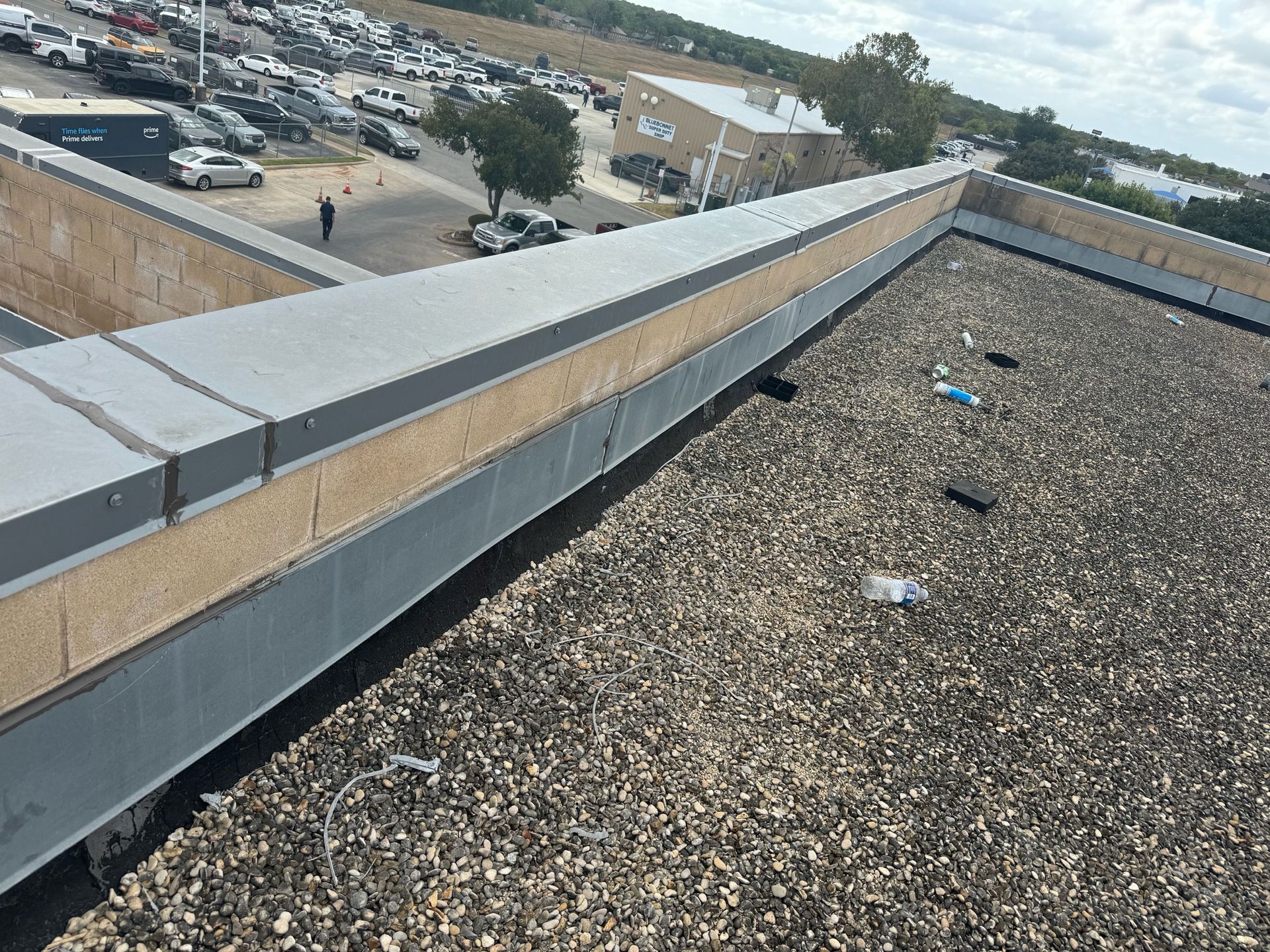 The roof of a building with a lot of gravel on it.