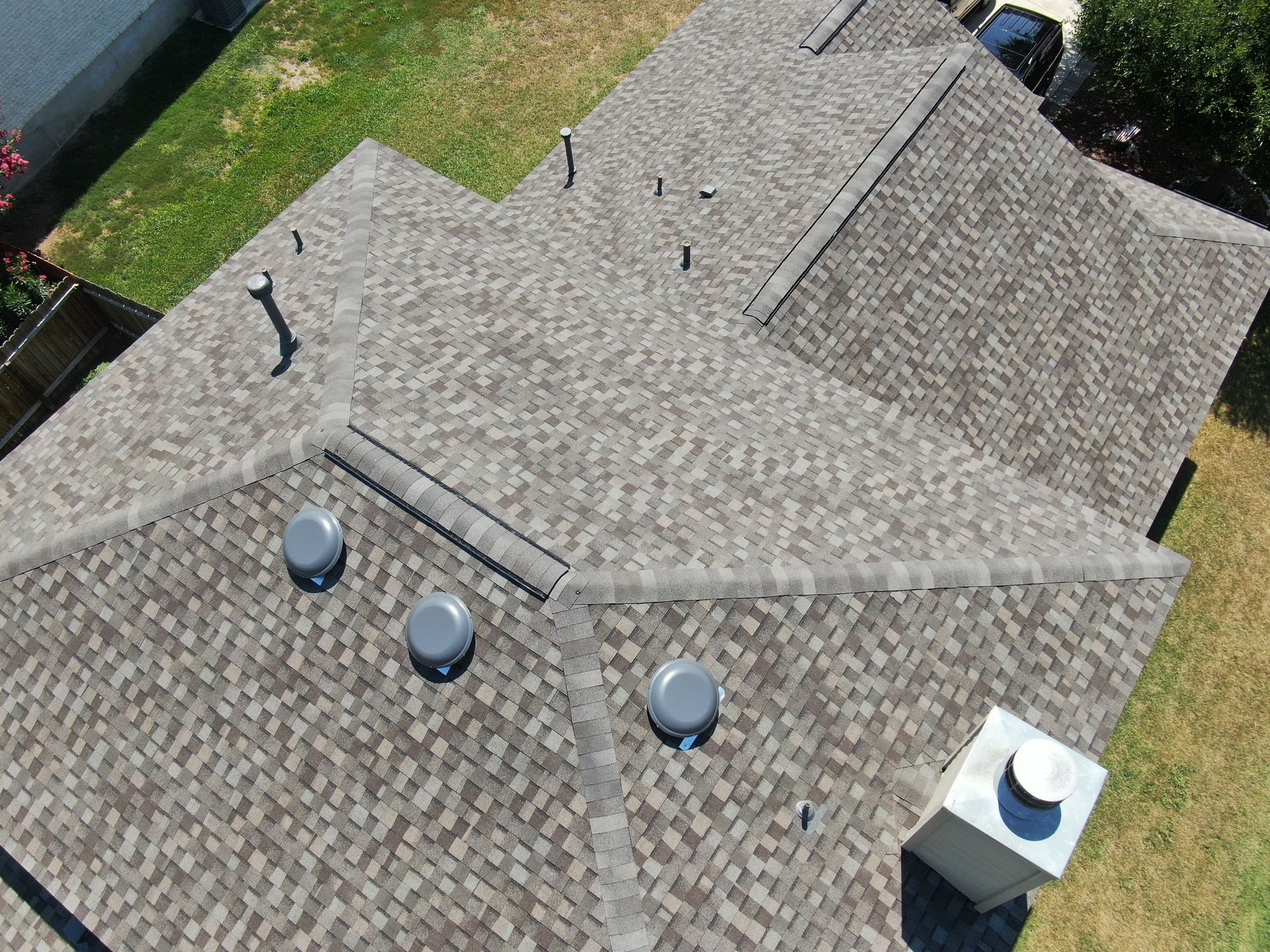 An aerial view of a roof with a lot of vents on it.