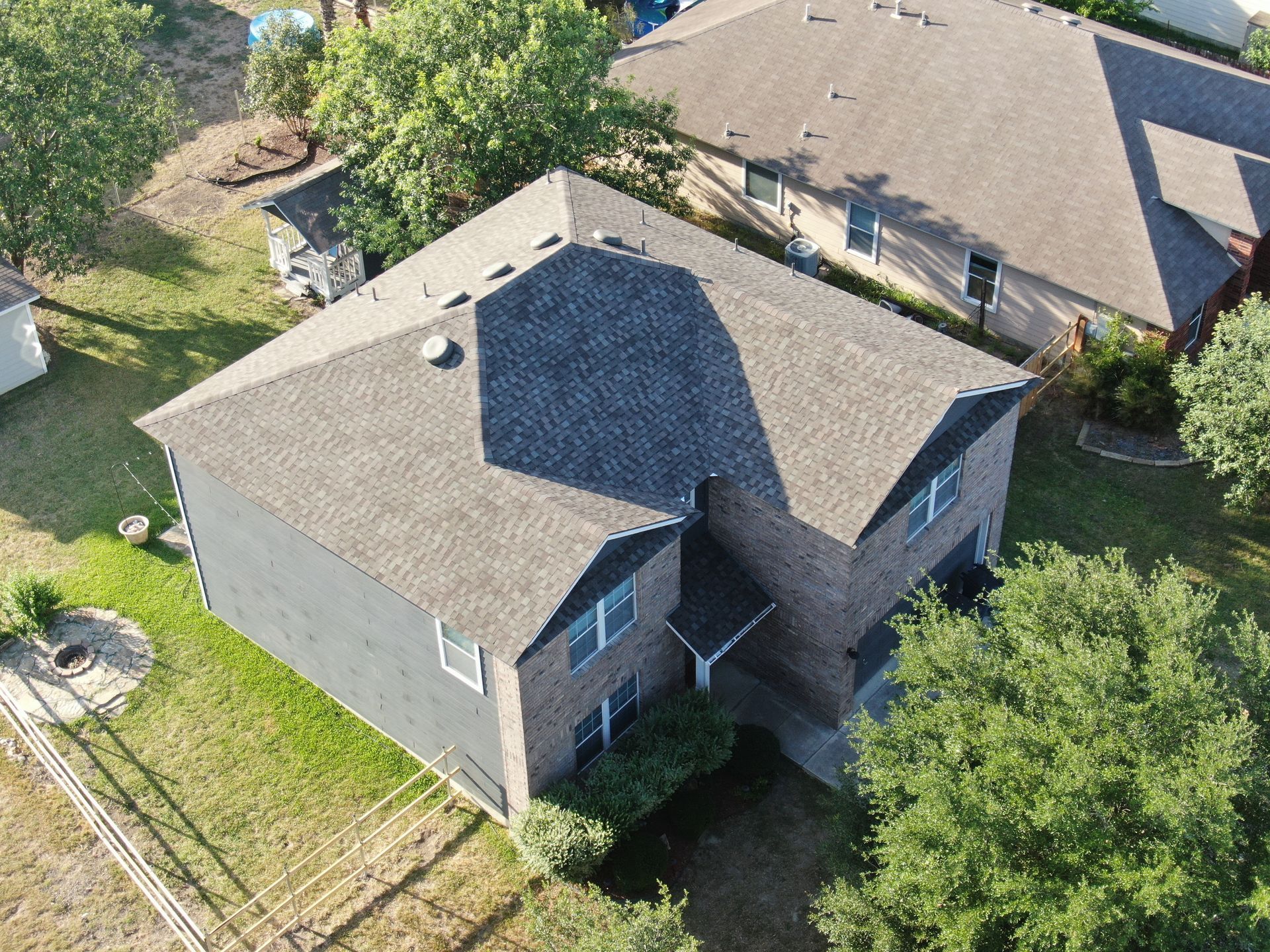 An aerial view of a house with a new roof.