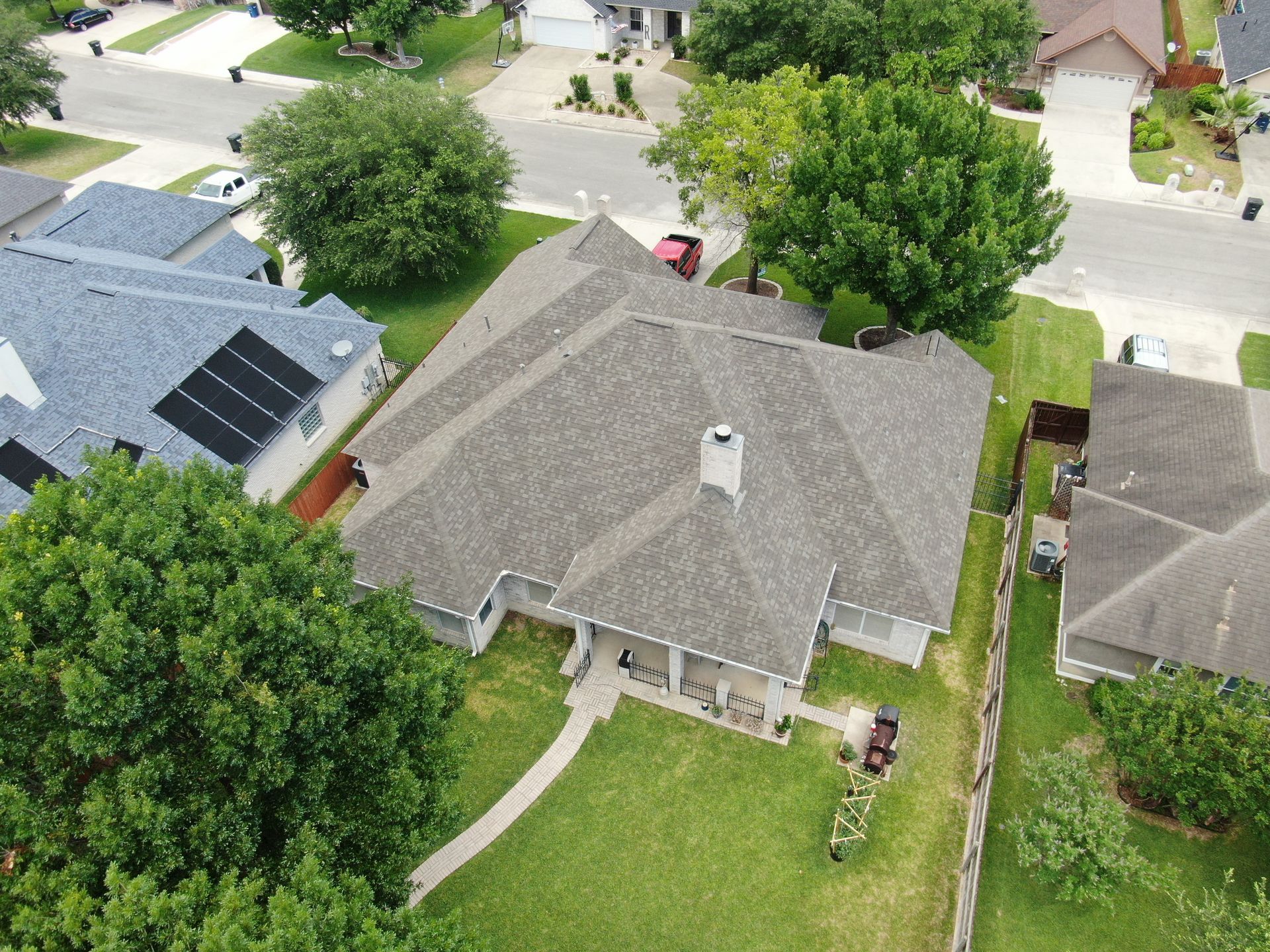 An aerial view of a house with solar panels on the roof