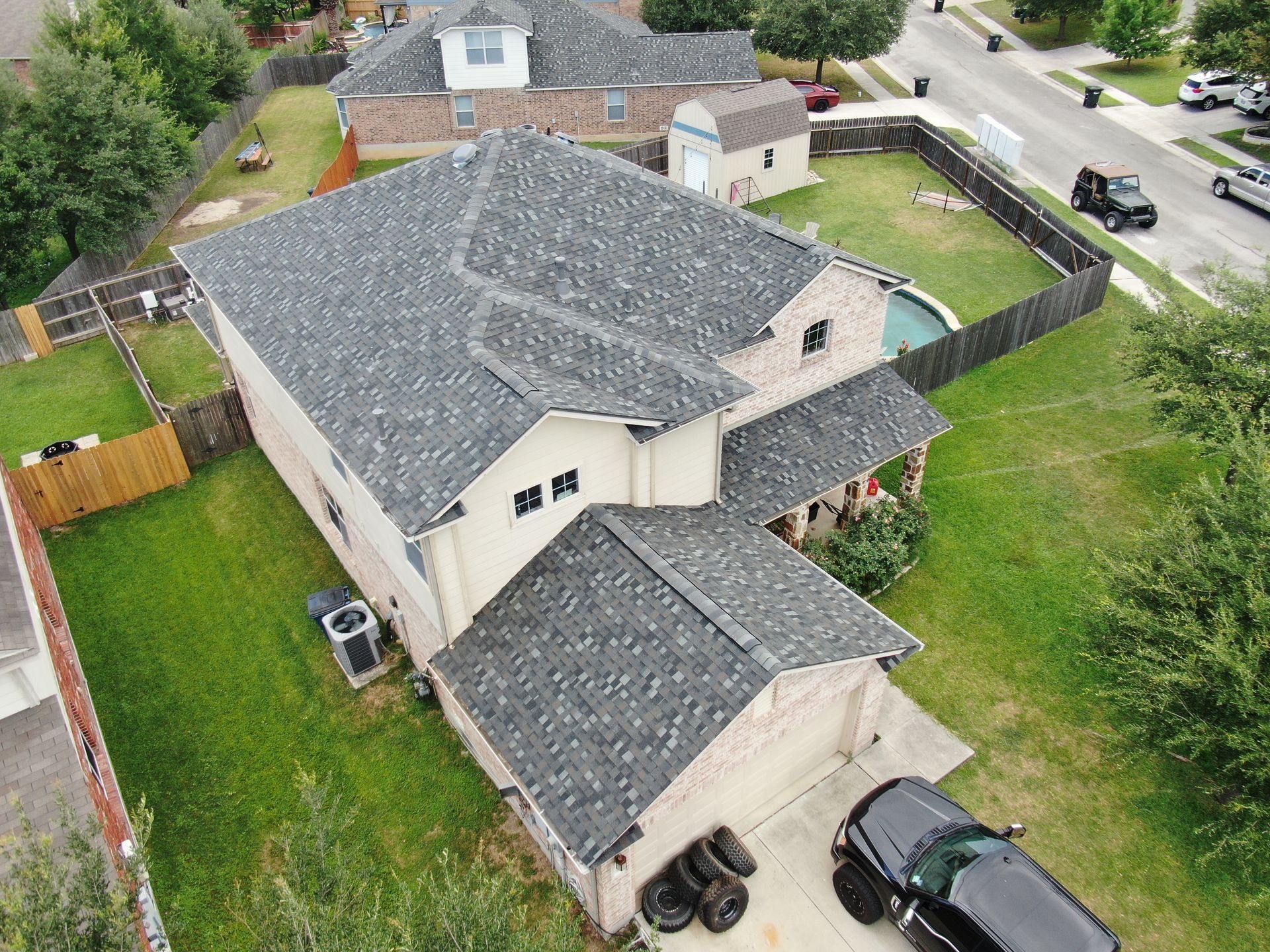 An aerial view of a house with a car parked in front of it.