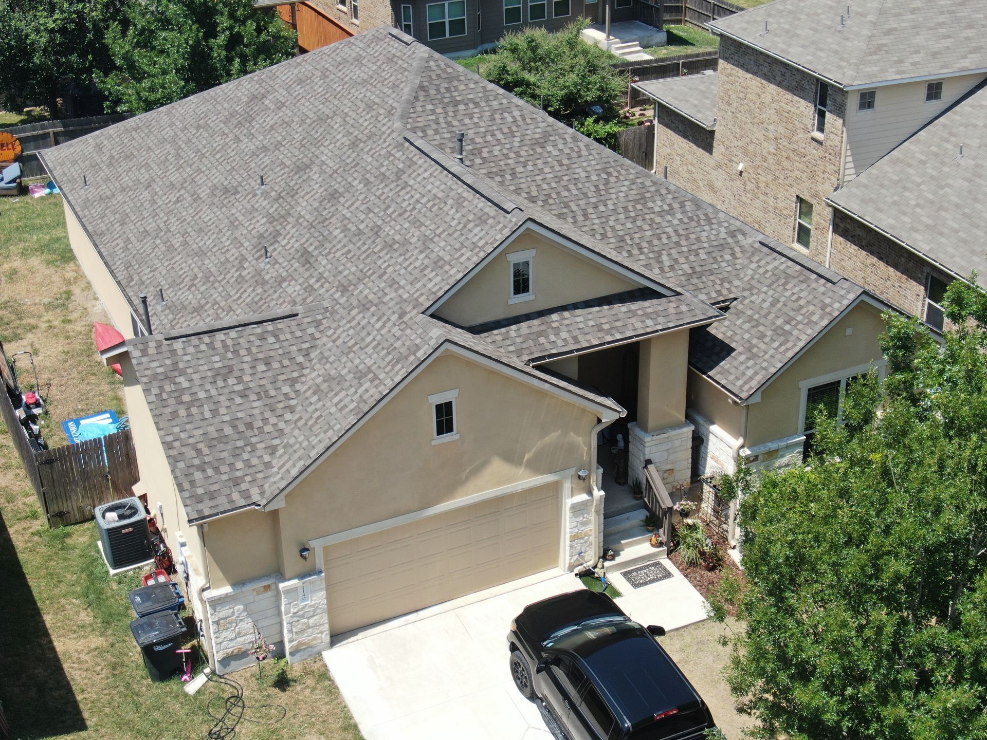 An aerial view of a house with a car parked in front of it.