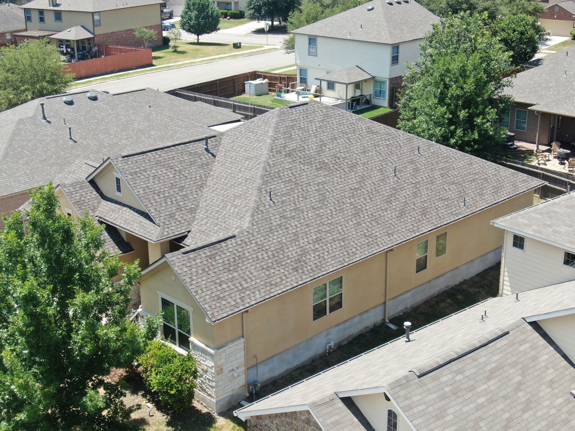 An aerial view of a house with a gray roof