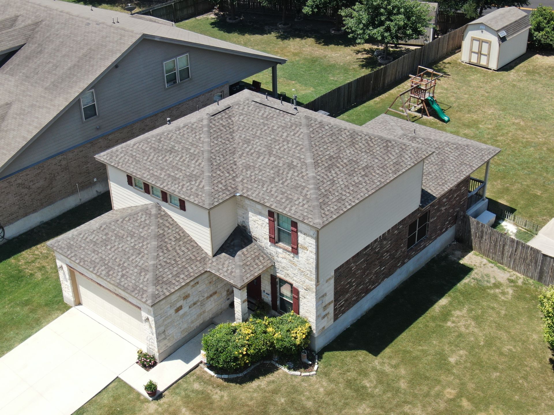 An aerial view of a large house in a residential area.