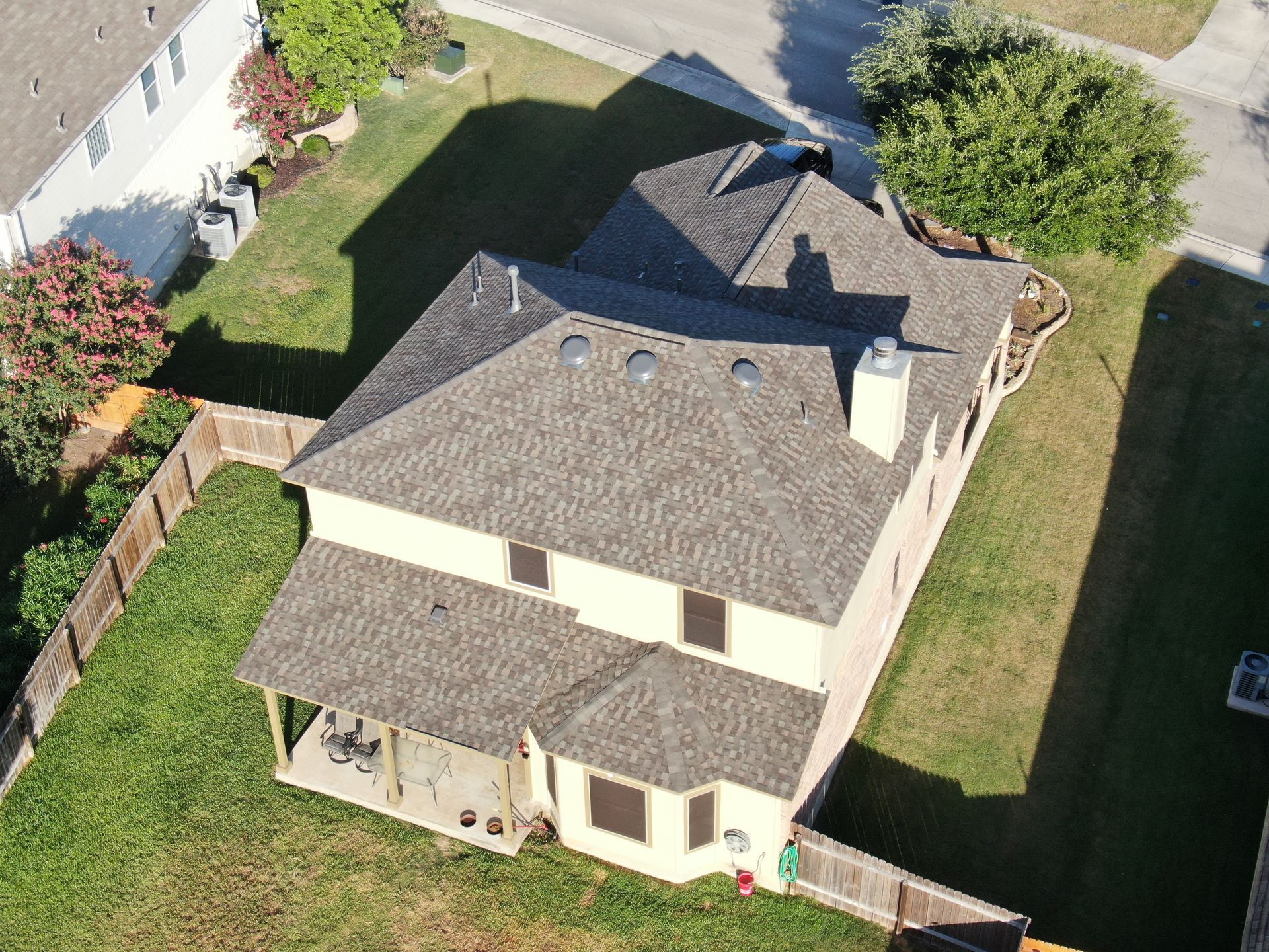 An aerial view of a house in a residential area