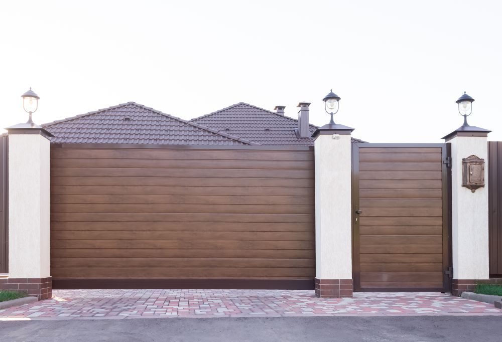 A House With a Sliding Garage Door and a Gate — Airlie Beach Garage Doors In Proserpine, QLD