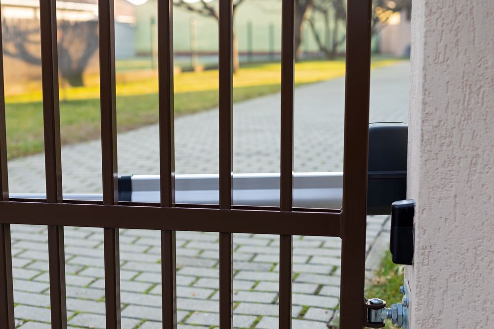 A Close Up of a Metal Gate With a Brick Walkway in the Background — Airlie Beach Garage Doors In Proserpine, QLD