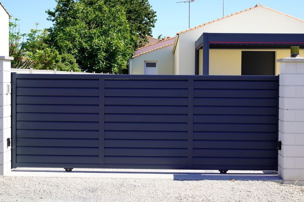 A Black Sliding Gate in Front of a House  — Airlie Beach Garage Doors In Cannonvale, QLD