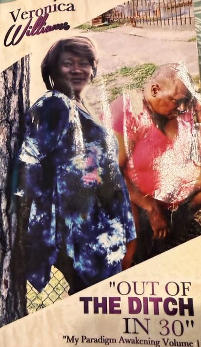 A woman is standing at a podium giving a presentation to a group of people.