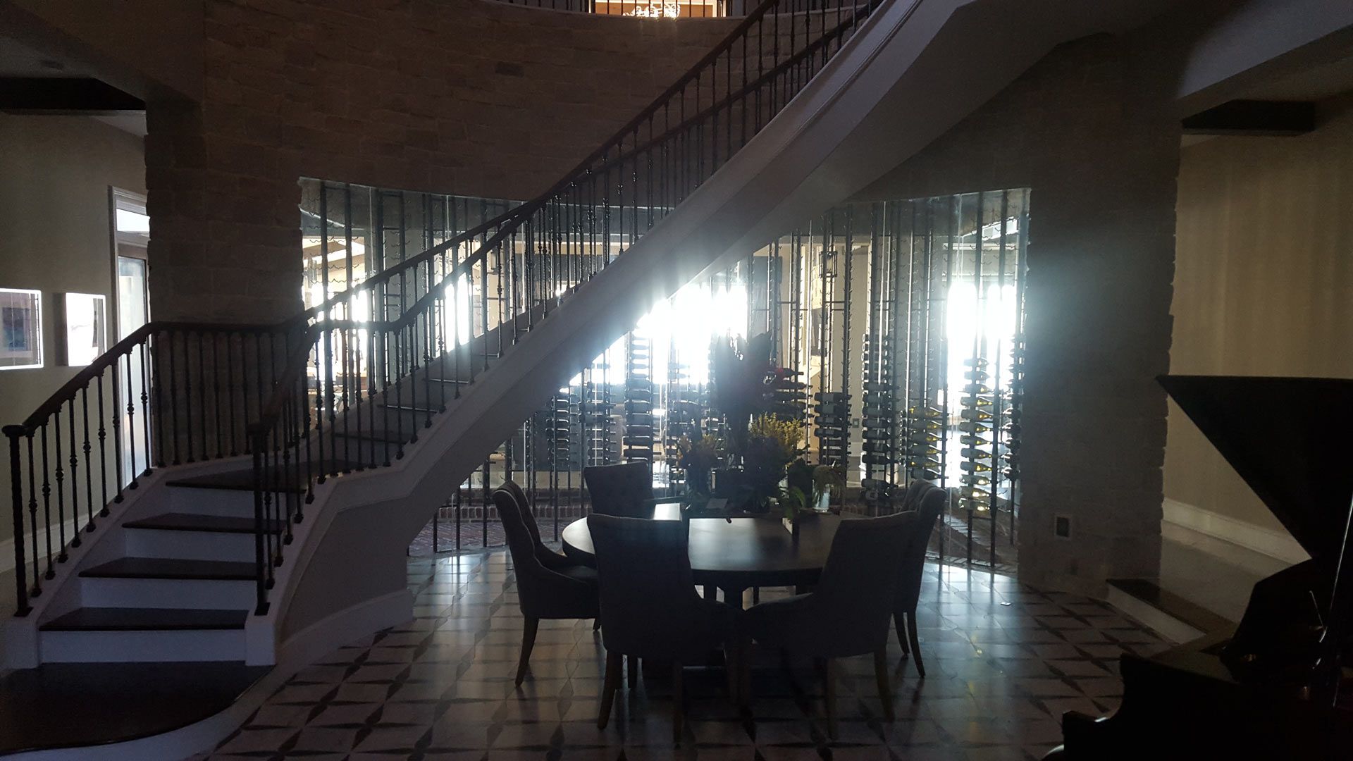 A dining room with a table and chairs and stairs — Pinellas County, FL —  R. J. Lange  & Son Inc.