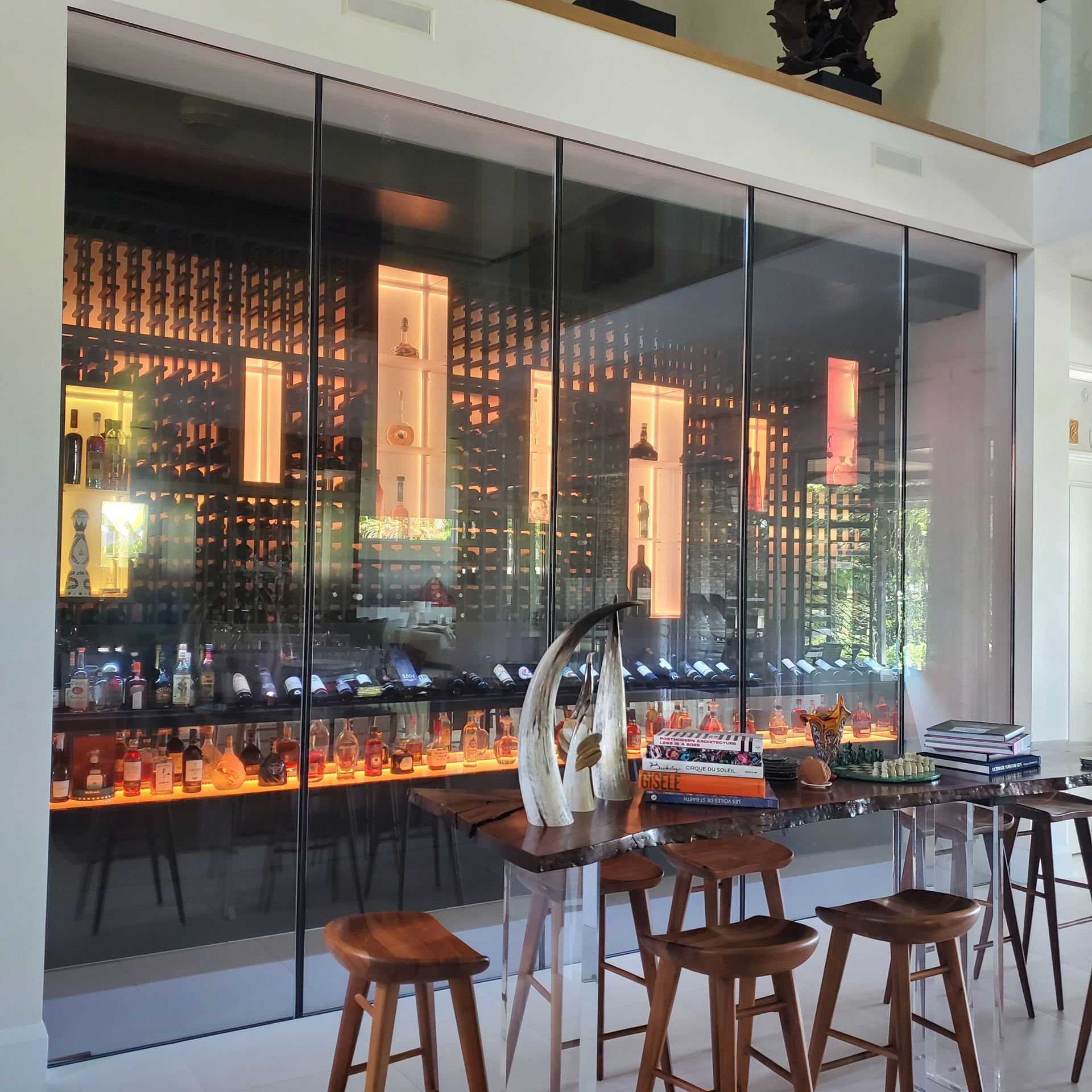 A room with tables and stools in front of a glass wall — Pinellas County, FL —  R. J. Lange  & Son Inc.