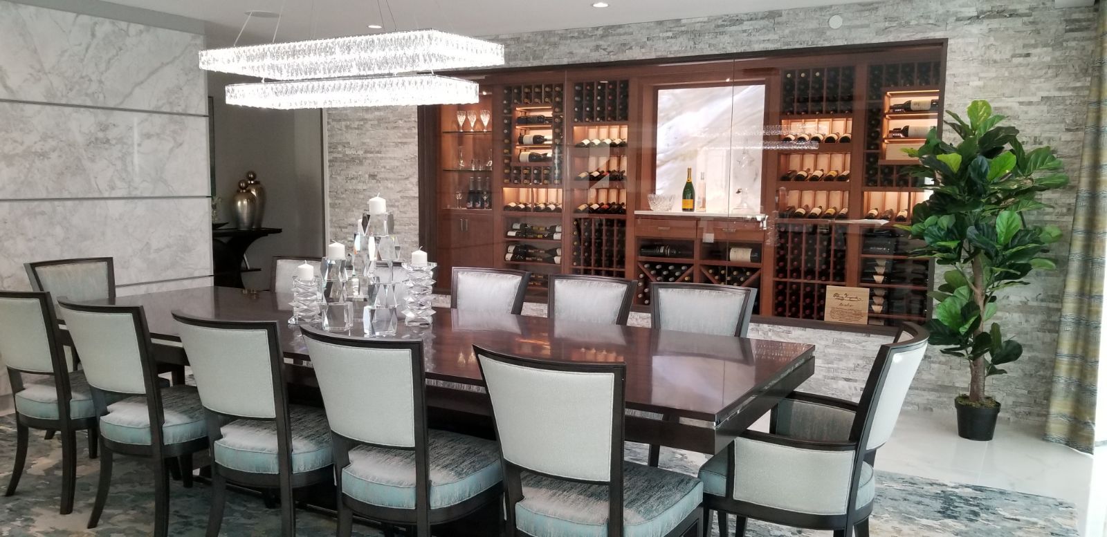 A dining room with a long table and chairs and a wine cellar — Pinellas County, FL —  R. J. Lange  & Son Inc.