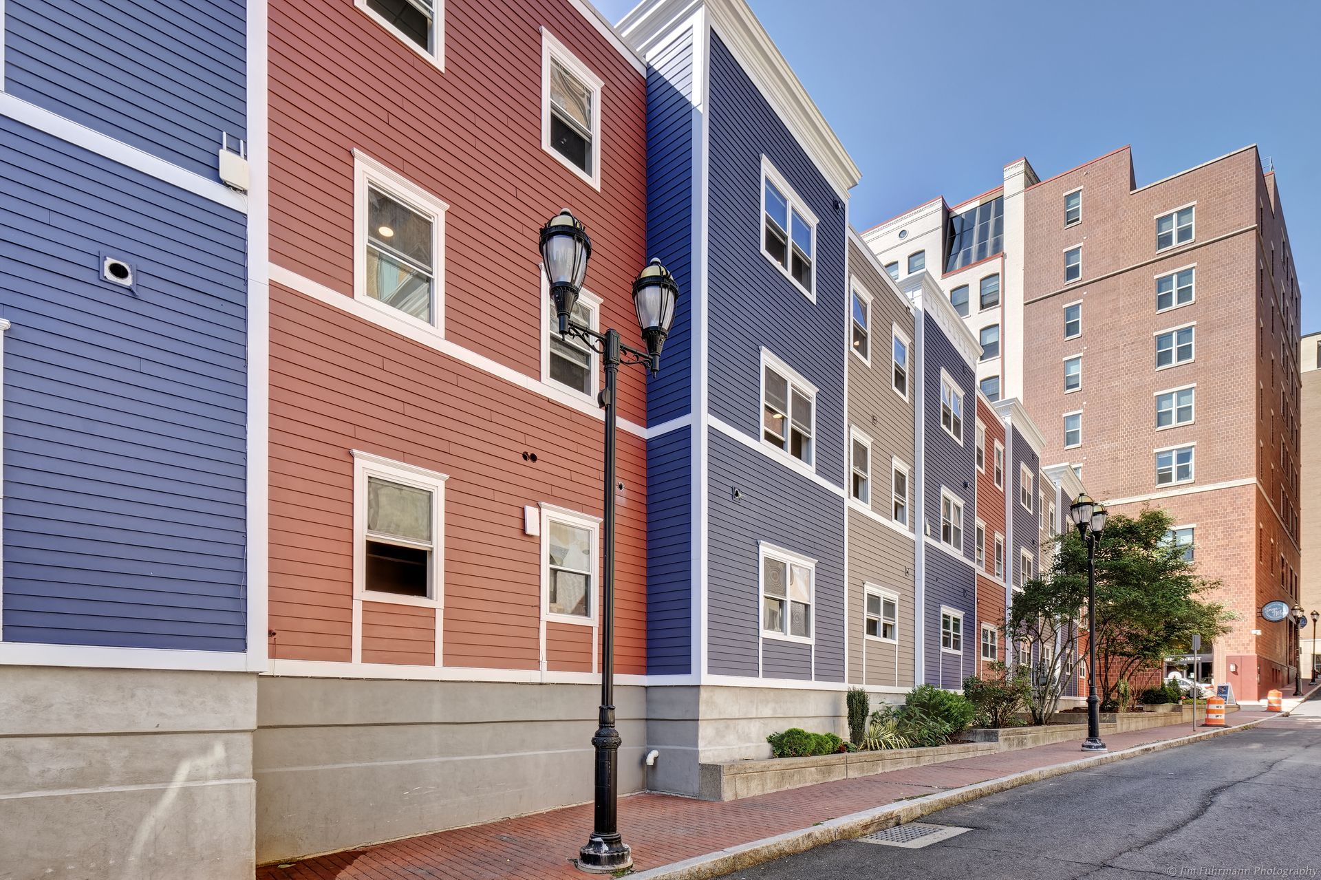 A row of colorful buildings with a street light in front of them