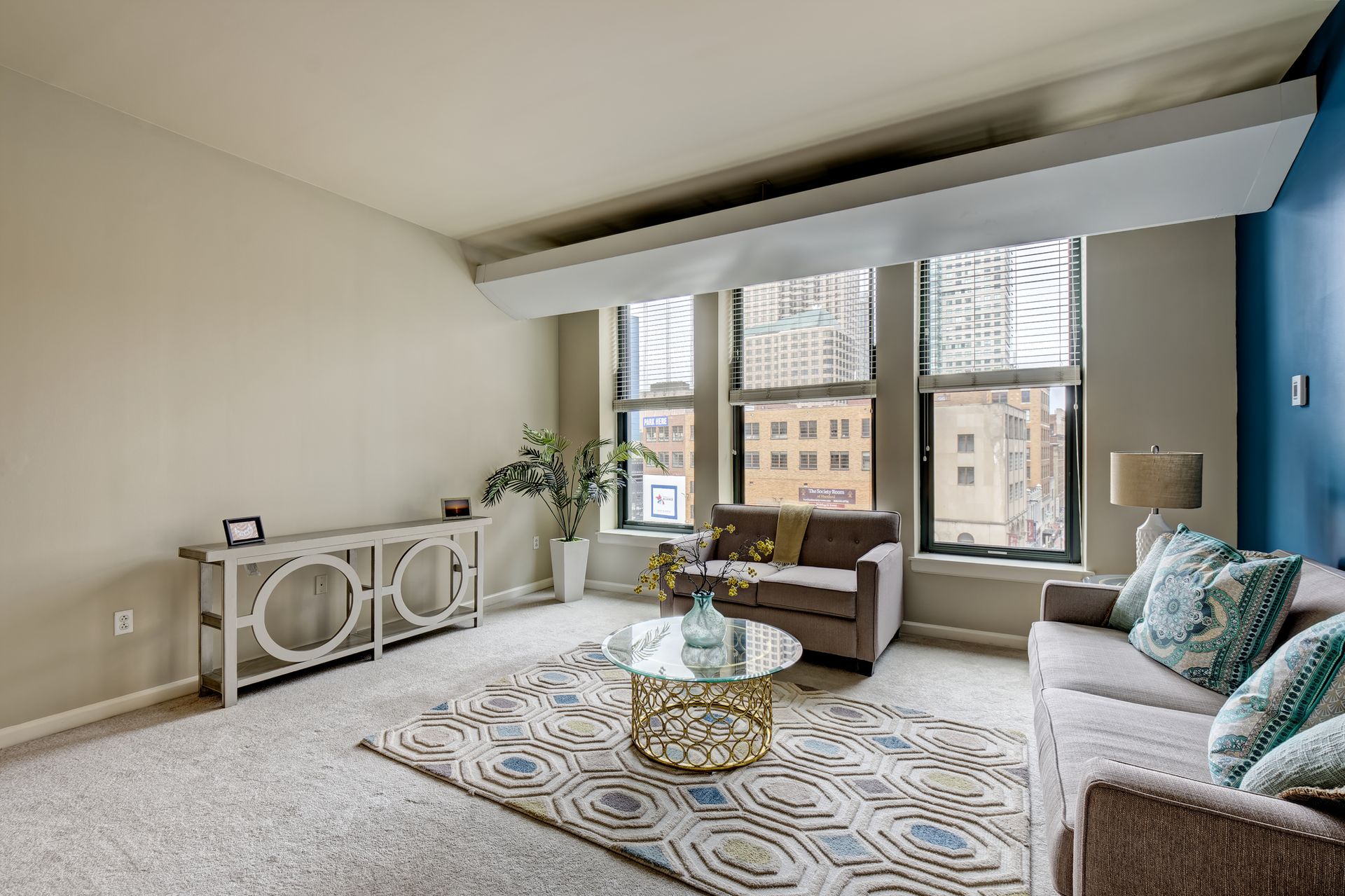 A large apartment building with a pond in front of it