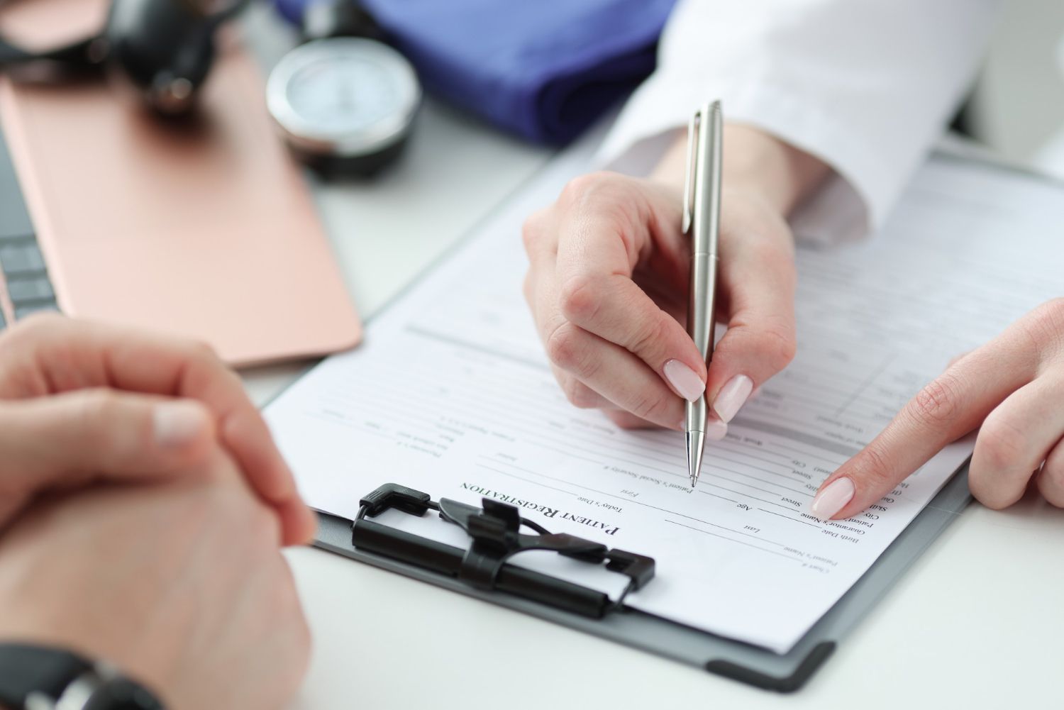 A woman is writing on a clipboard with a pen.