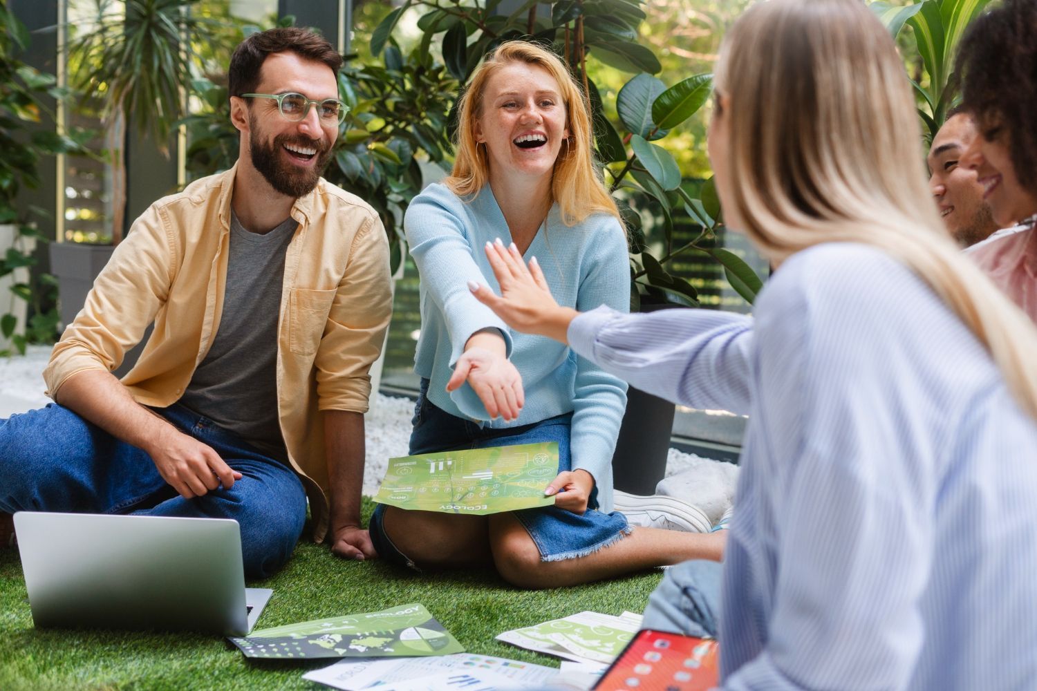 A group of people are sitting around a table having a meeting.