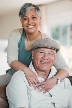 an older man is hugging a younger woman