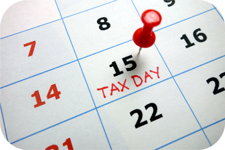 A calendar with a red pin that says tax day