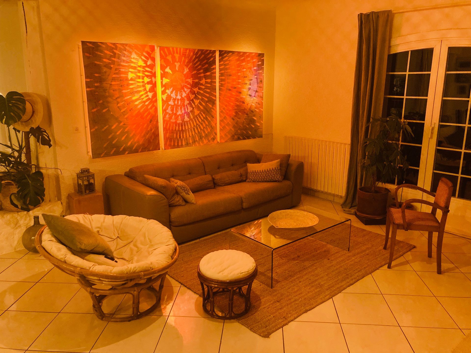 Living room with brown sofa, art, chair, and rug.