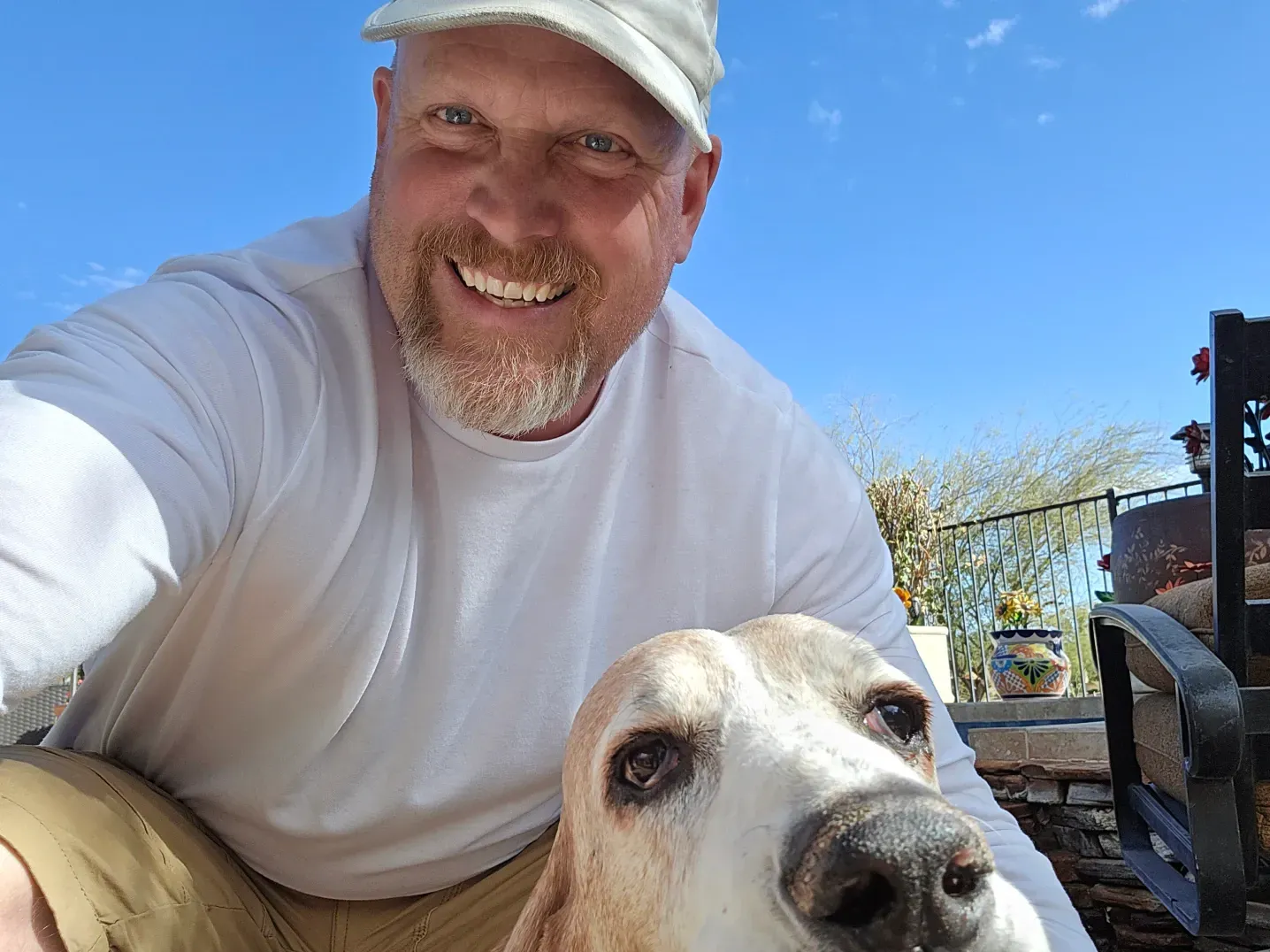 A man is taking a selfie with his dog.