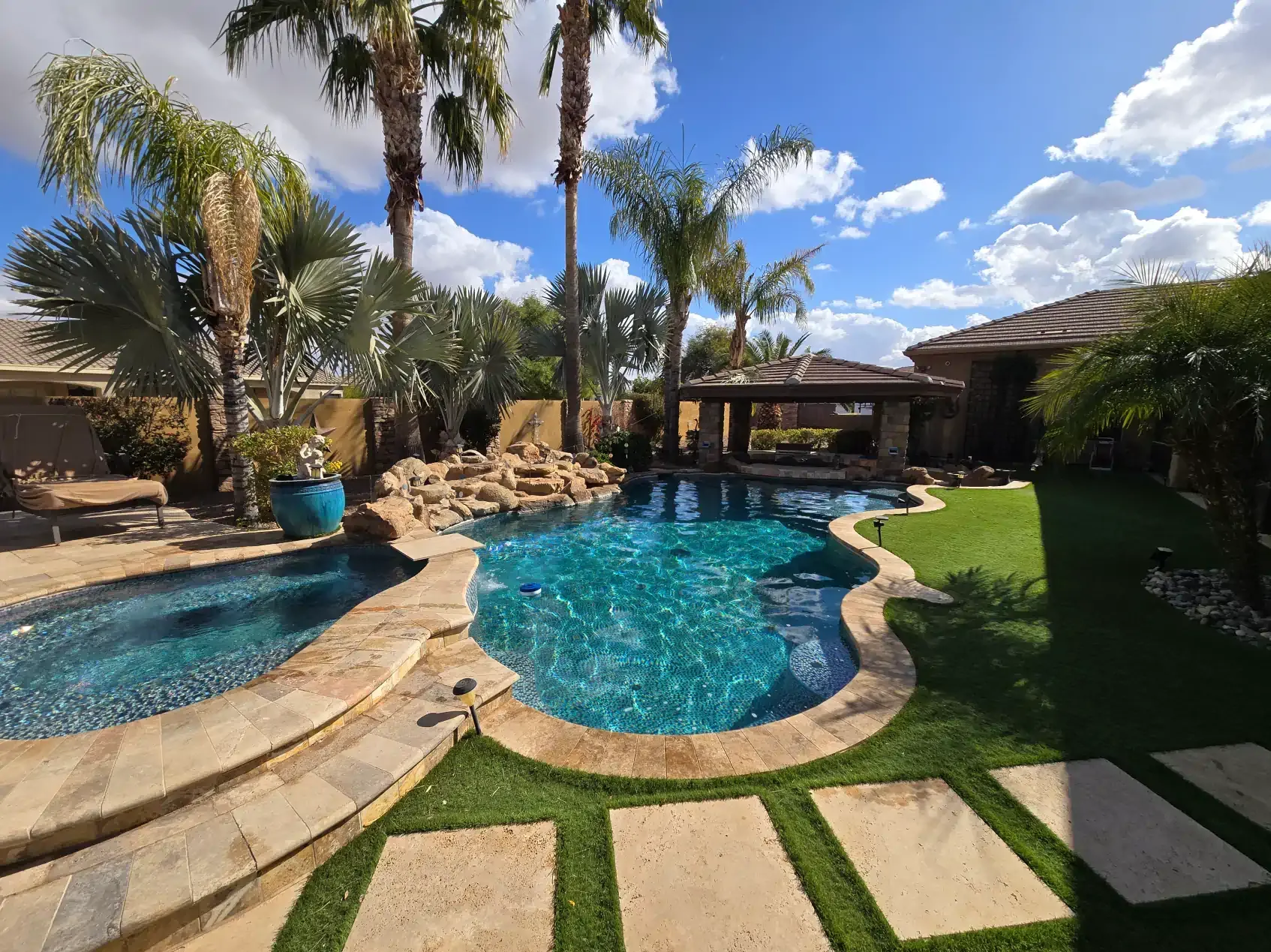 A large swimming pool in the backyard of a house