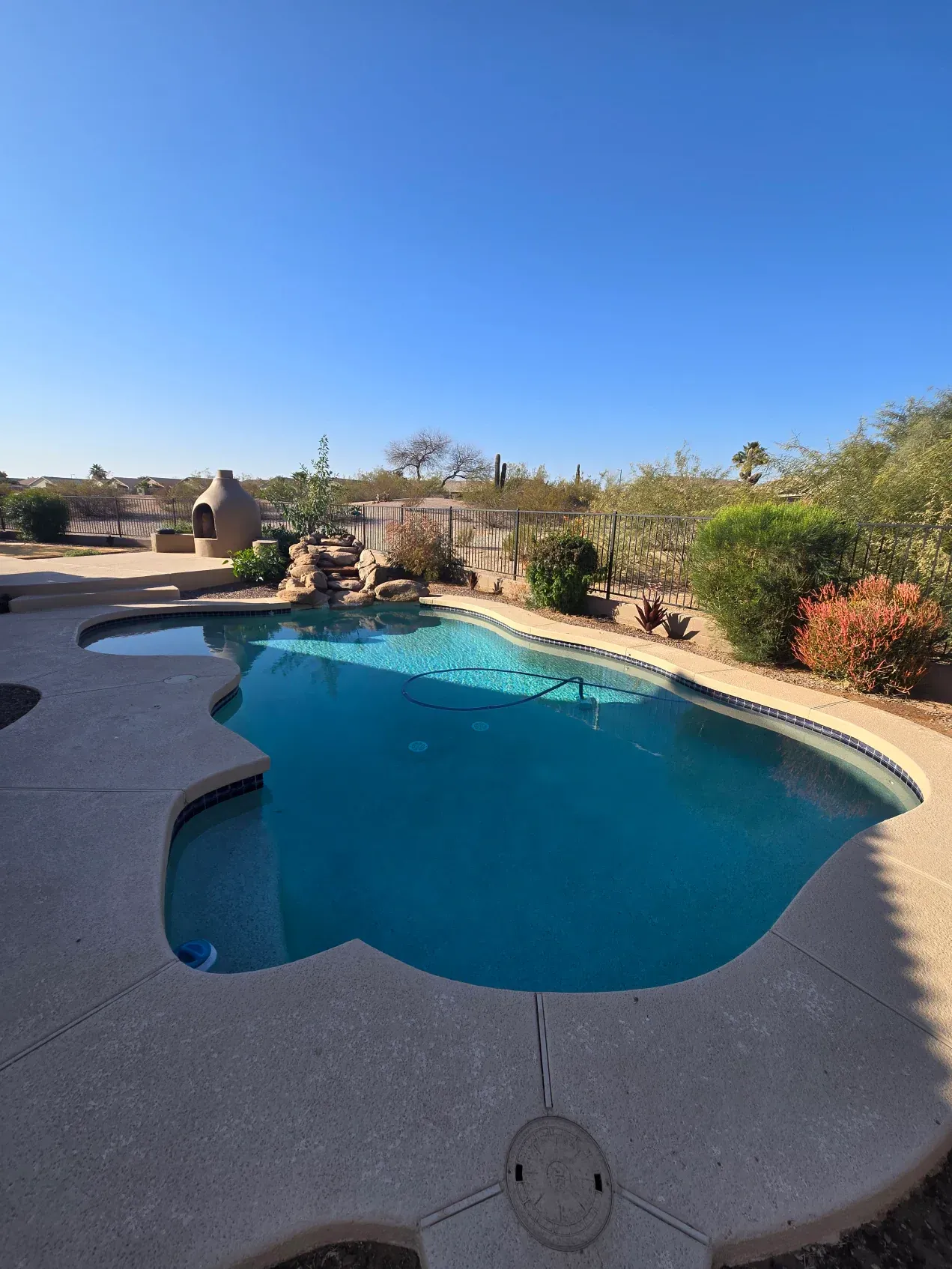 A large swimming pool in the backyard of a house