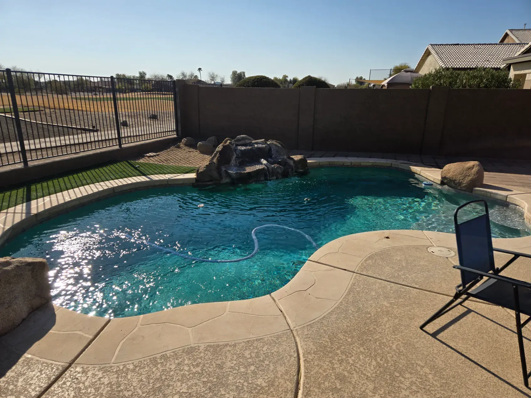 A large swimming pool with a chair in front of it