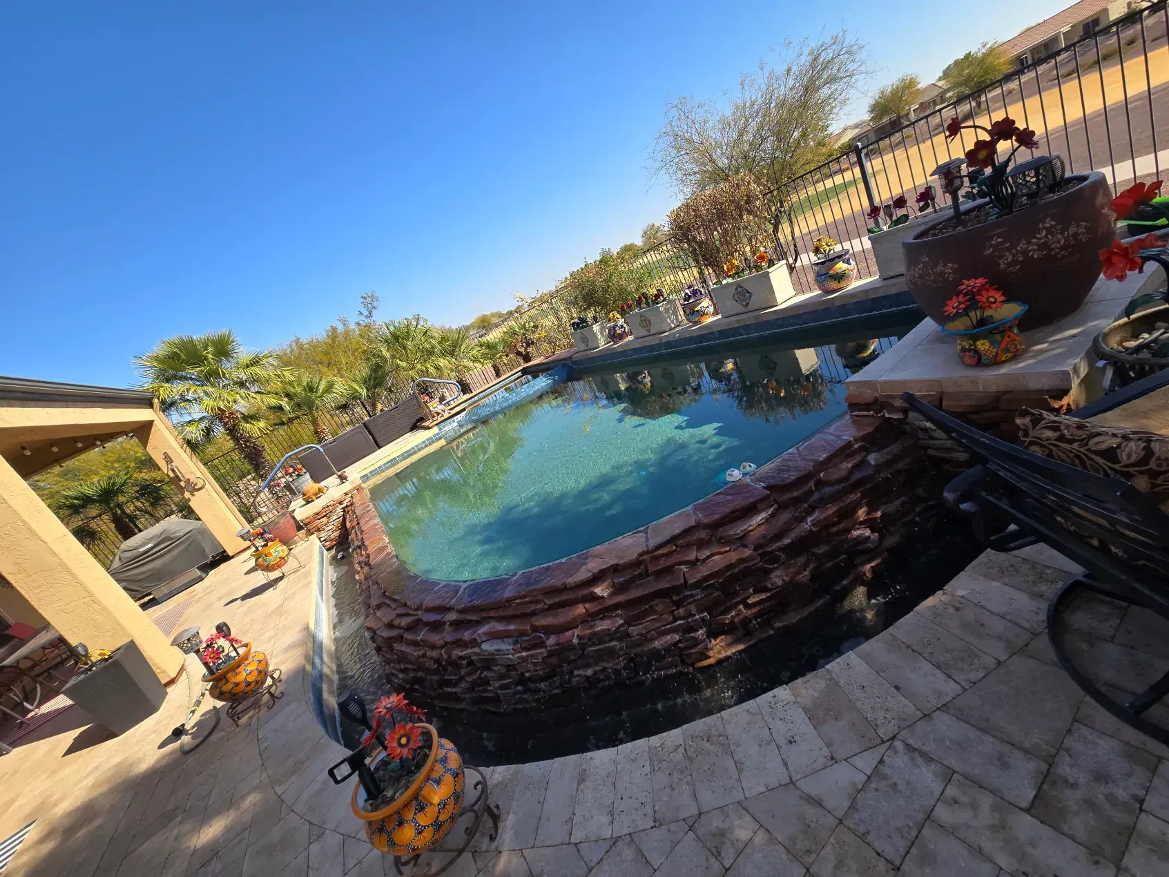 A large swimming pool is being cleaned by a vacuum cleaner.