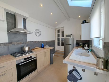 kitchen with grey tiles and white walls and stainless steel fittings