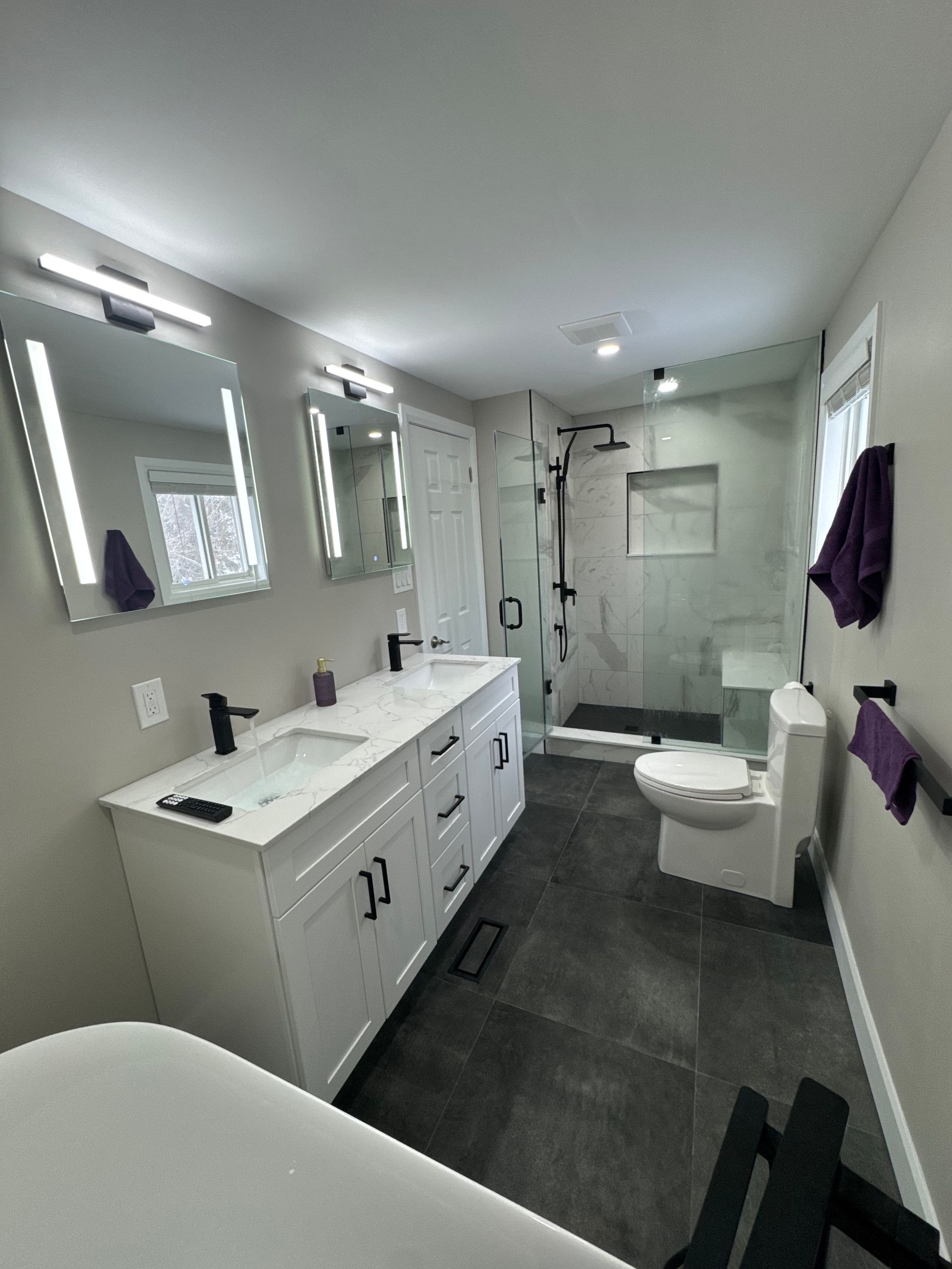 A bathroom with a sink , toilet , and shower.