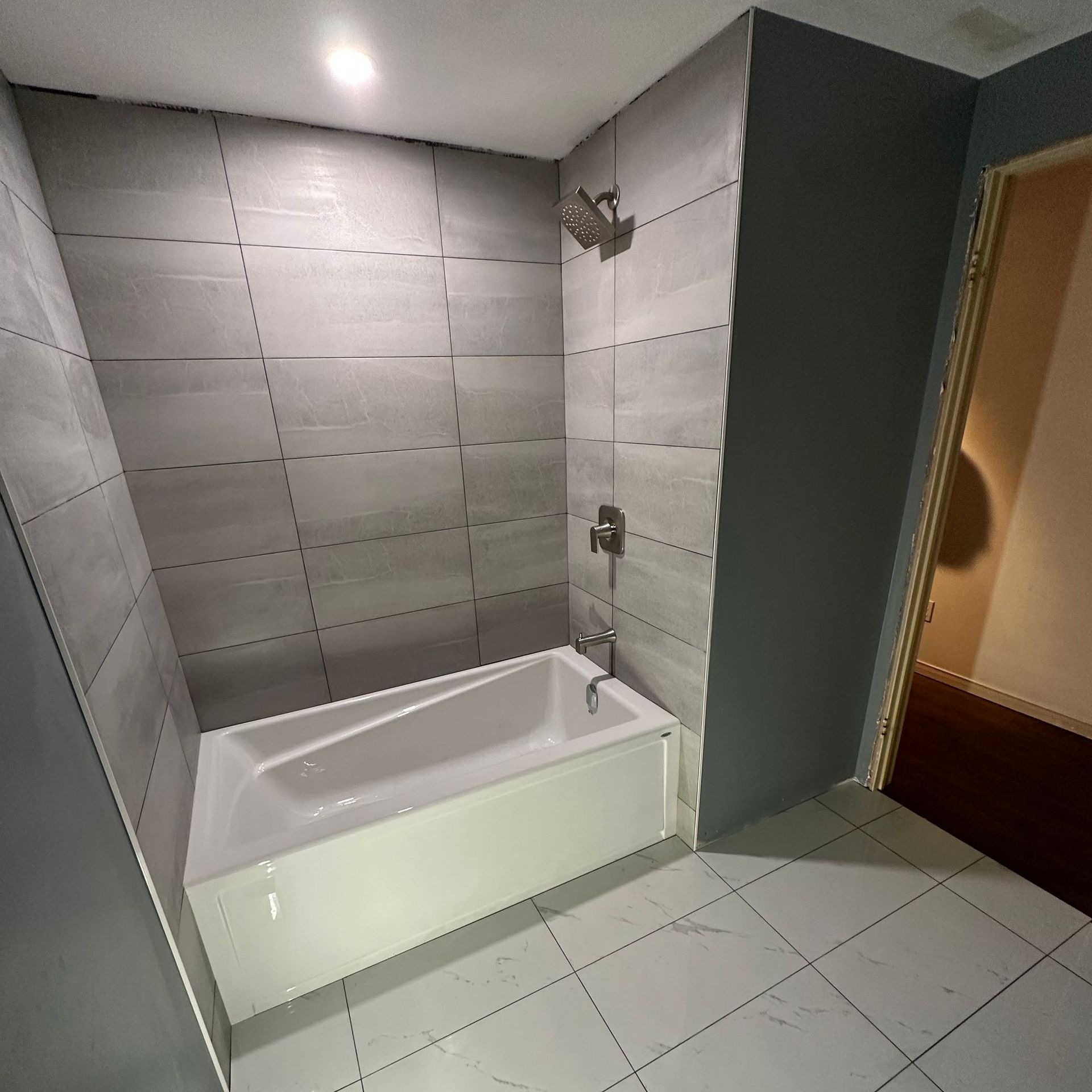 A bathroom with a bathtub and a shower.