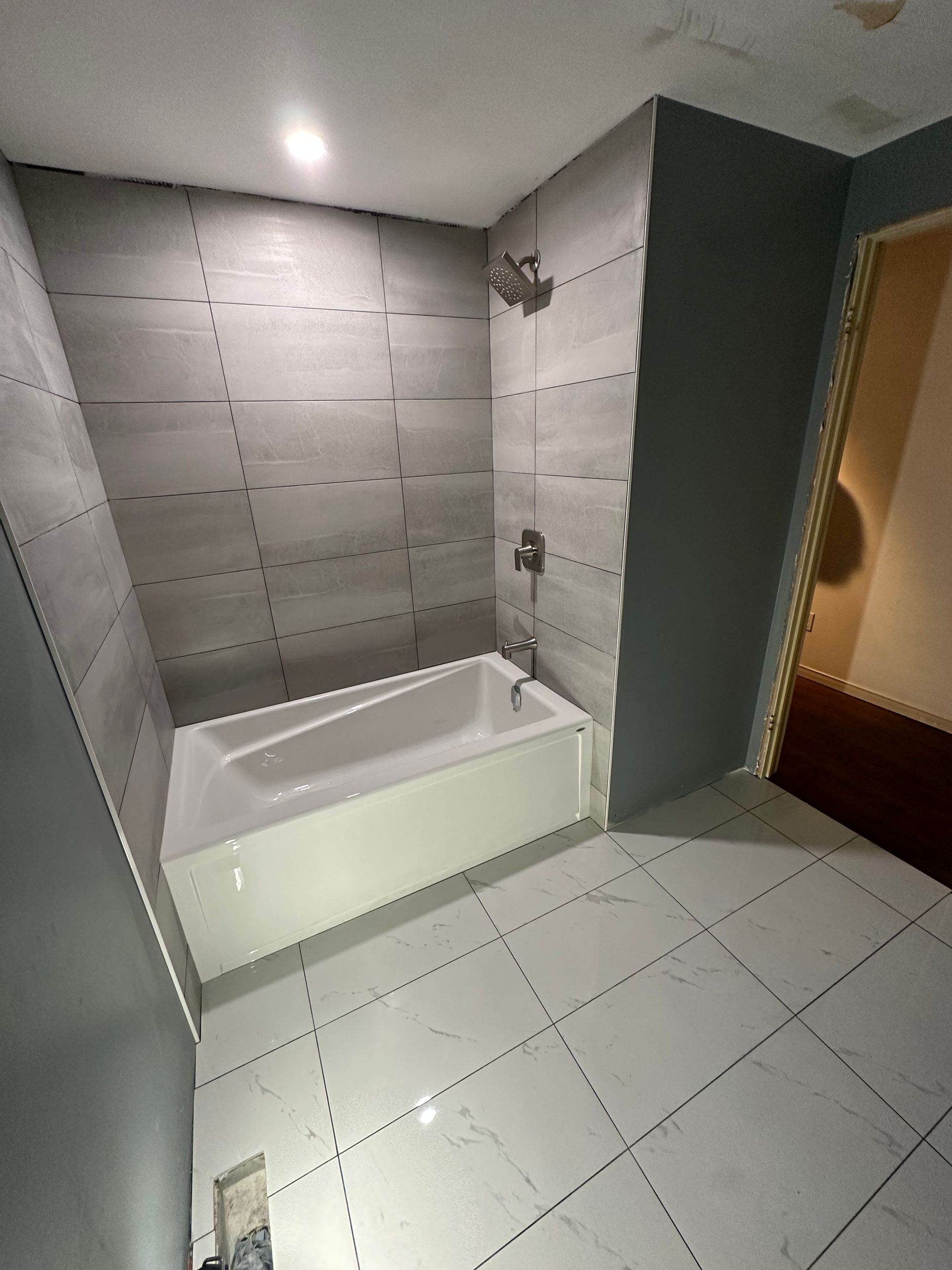 A bathroom with a bathtub and a shower.