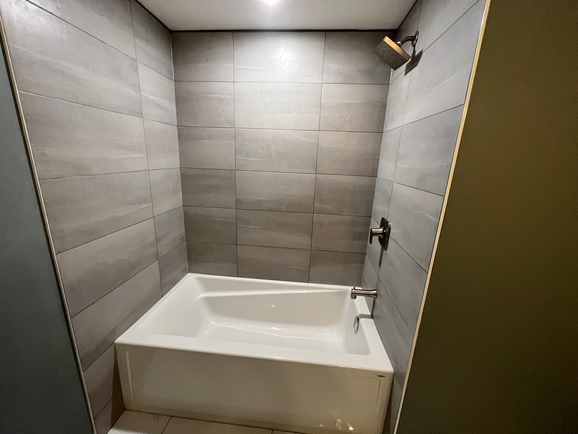 A bathroom with a bathtub and a shower.