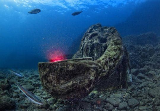 Underwater volcano with glowing red lava.