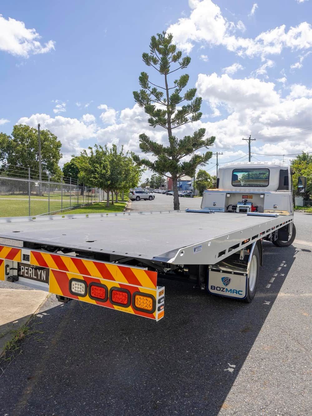 A Flatbed Tow Truck is Parked on the Side of the Road  — Perlyn Towing  in Rockhampton City, QLD