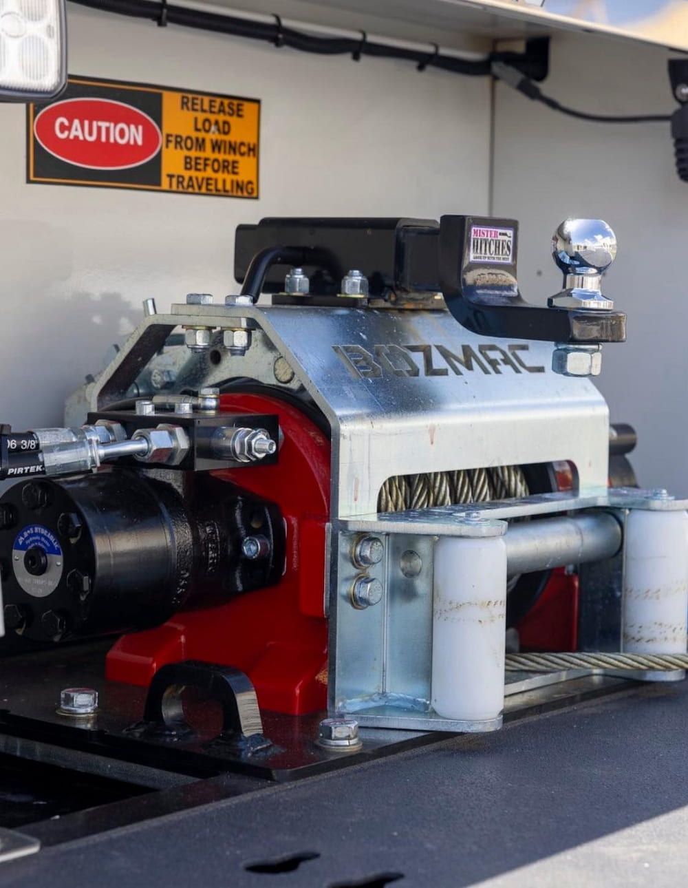 A Winch With a Caution Sign Above It — Perlyn Towing  in Rockhampton City, QLD
